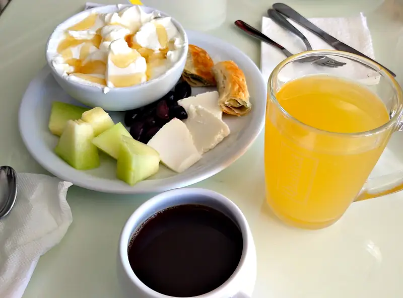 Breakfast plate with fruit, cheese and orange juice