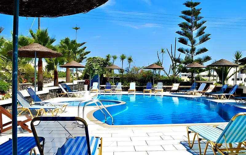 Pool with palms and umbrellas